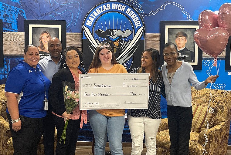 Sarah Wallace (center) is surprised to learn she was selected to receive a full prom makeover, including a new dress and shoes. From left, Matanzas teacher Janel Walker and SALT's Cyril Stubbs, Aisha Stubbs, Yonette Turner and Shania Stubbs. Courtesy photo.