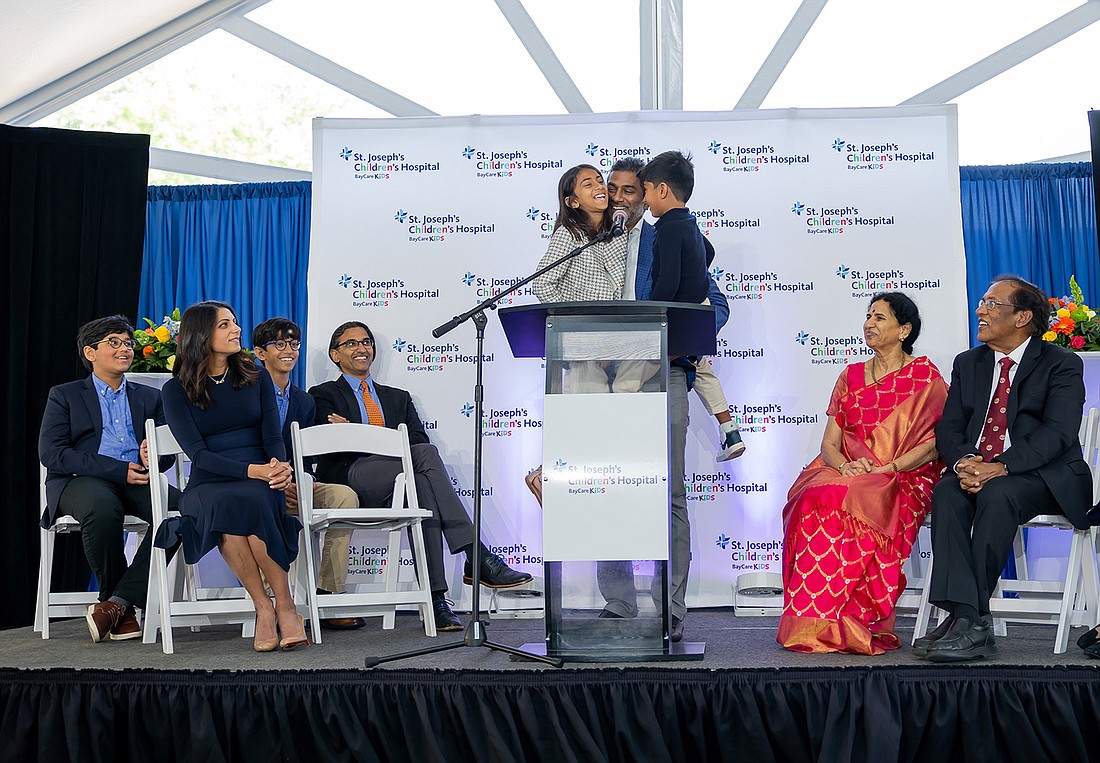 Sidd Pagidipati, with his children, announcing a $50 million donation as the family looks on. Dr. Rudrama Pagidipati, in red, and Dr. Devaiah Pagidipati, are to his left.