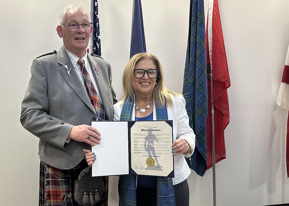 Jim Leishman, mayor of Dunfermline, Scotland, and Sarasota Mayor Liz Alpert pose April 10 after signing a renewal of their Sister City relationship.