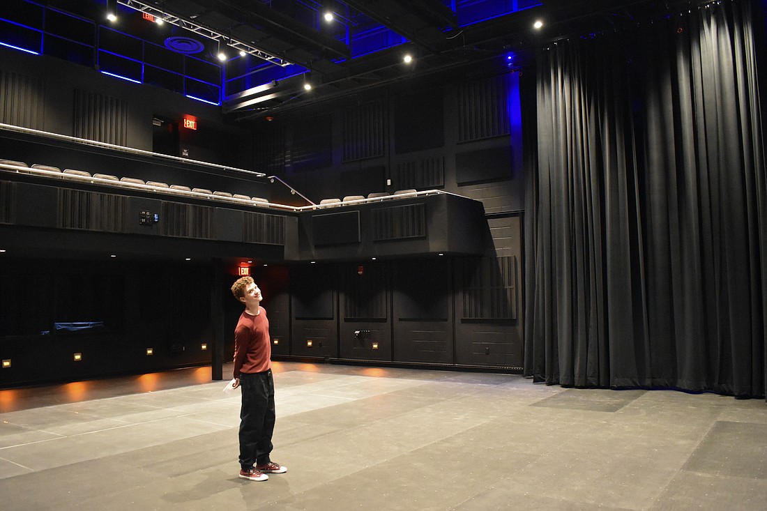Federico Hradek stands in the black box theater space.