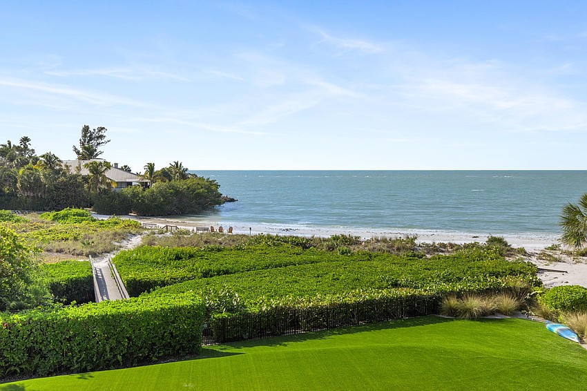 The home is set on a sprawling 1.6-acre compound with separate guest/staff quarters and access to a secluded beach.