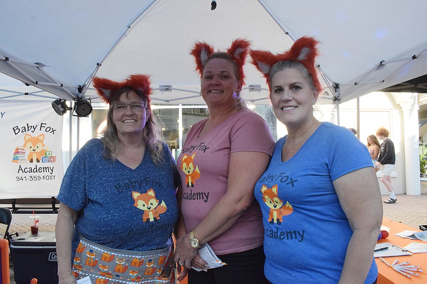 Baby Fox Academy infant teacher Katie Evans, voluntary pre-K teacher Jana Tardiff and preschool teacher Debbie Mottad provide activities for children while dressed as foxes.
