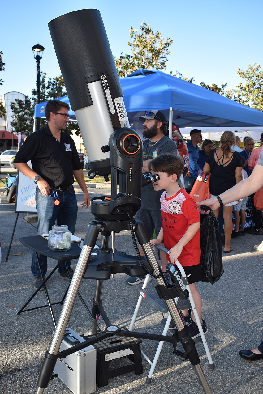 Charlie Meserve looks at the moon through a big telescope.