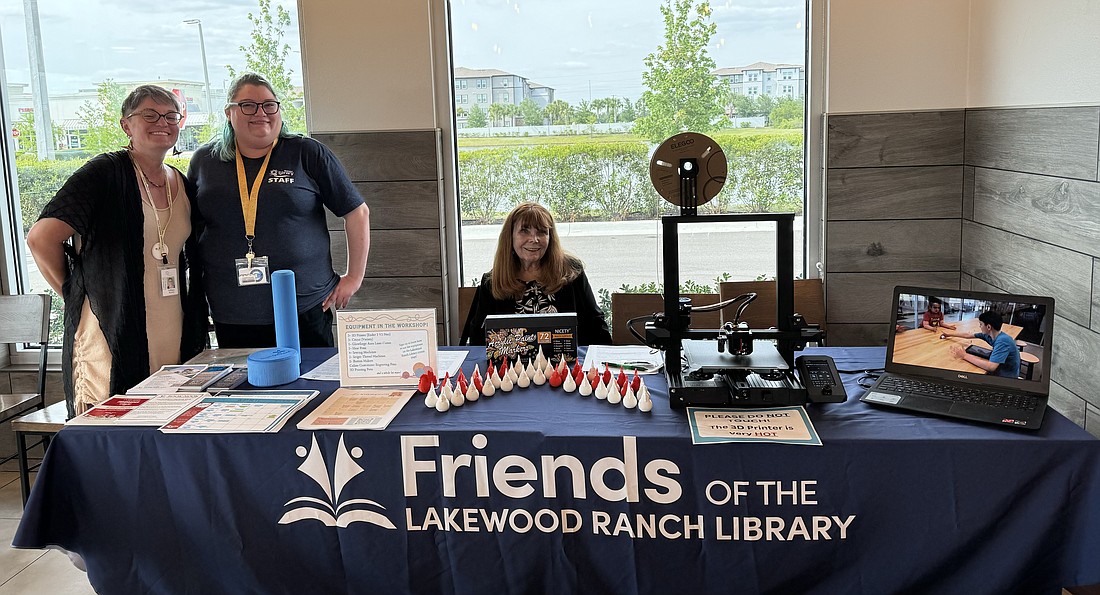 Tiffany Mautino, the Lakewood Ranch Library supervising manager, Hayley Rigatti, a library staff member, and Faith Kibler, a Friends of the Lakewood Ranch Library volunteer, bring a button maker and 3D printed chicks for people to paint while supporting the nonprofit and Slim Chickens.