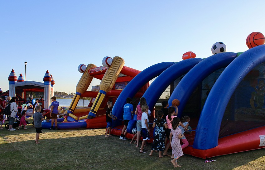 Inflatables are set up at Waterside Park for Movie in the Park.