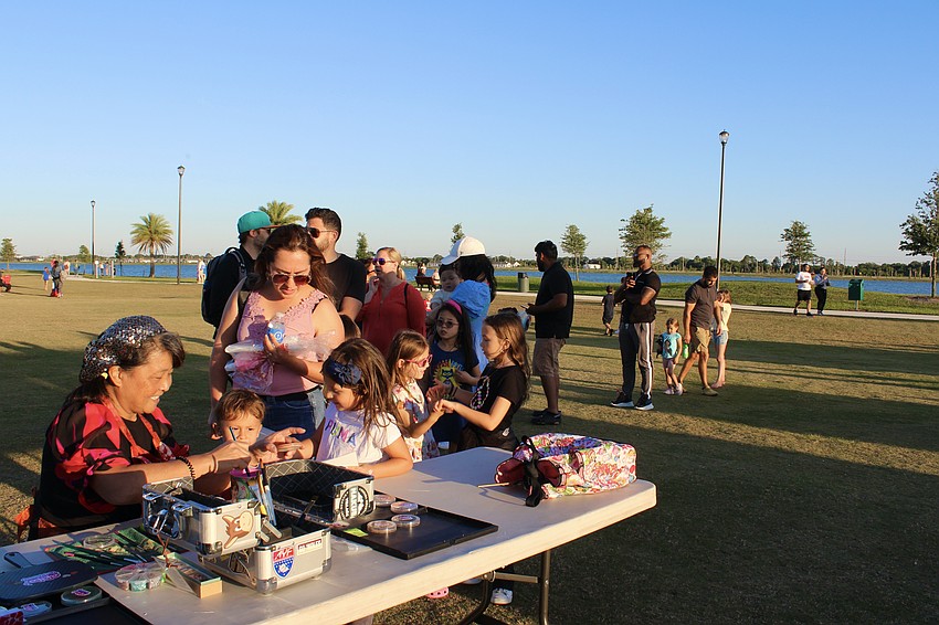 Kids line up to have their faces painted before the movie starts.