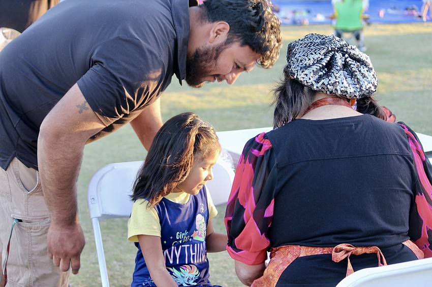 Jose and Alejandra Garcia look over the face painting menu.