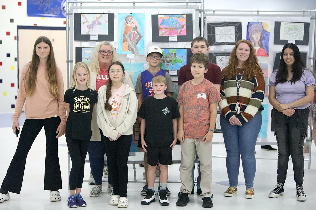 Buddy Taylor Middle School student-artists pose with art teachers Jennifer Brooks and Megan Kisner at the Celebration of the Eagle Arts spring event on April 12. Photo by Brent Woronoff