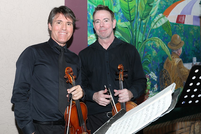 From Sarasota Orchestra are violinists Sean O'Neil and Paul Reynolds who played classical music during the cocktail reception.