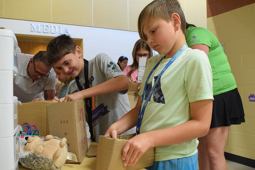 Fourth grader Parker Poplaski and fifth grader Ethan Drackett are hard at work constructing a container that could carry a stuffed animal.