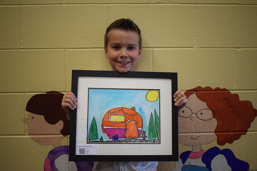 Second grader Jase Piercy beams with pride about his artwork.