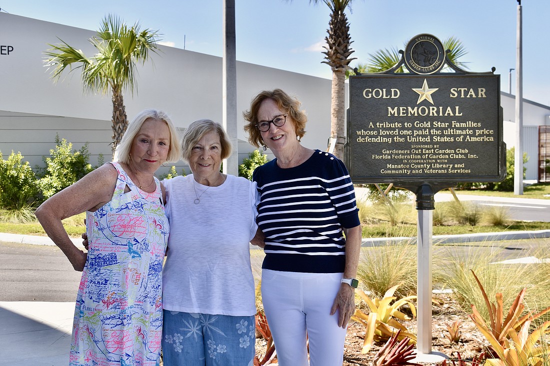 Gardeners Out East members Carolyn Lowry-Nation, Nancy Schneider and Melodie Friedebach stand by the Gold Star Memorial installed by the club at the Lakewood Ranch Library.