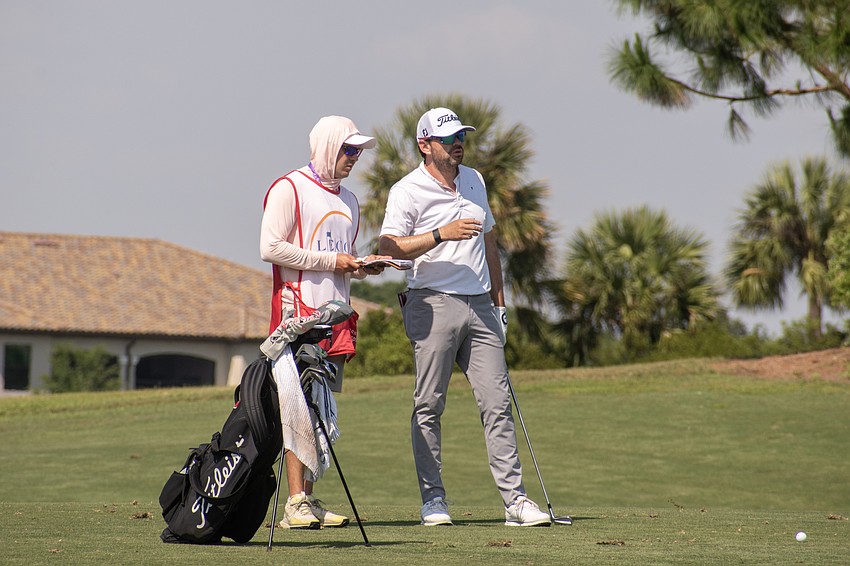 Marcelo Rozo talks to his caddy before his second shot on the No. 18 hole at Lakewood National Golf Club during round two of the 2024 LECOM Suncoast Classic. Rozo shot four under par Friday and is eight under par for the tournament.