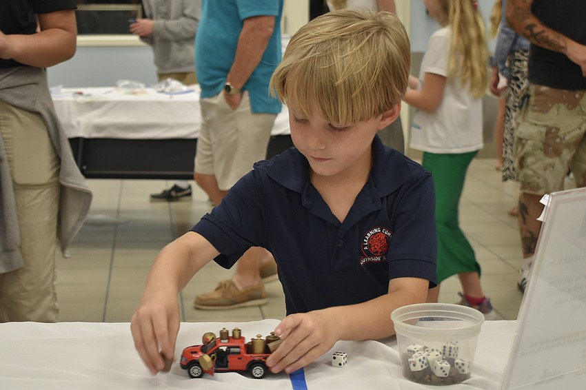 Kindergartener André Andreiko experiments with a toy car.