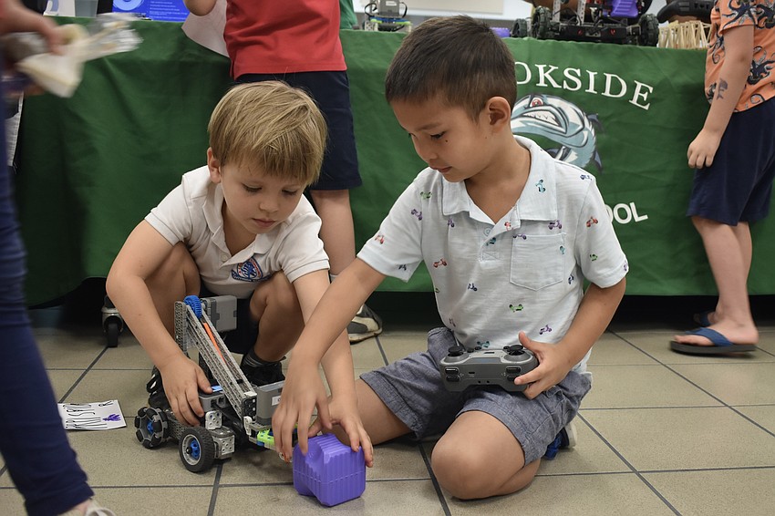 Kindergartener JT Lannon and his cousin, Pre-K student Ryan Ching, play with a VEX robot.