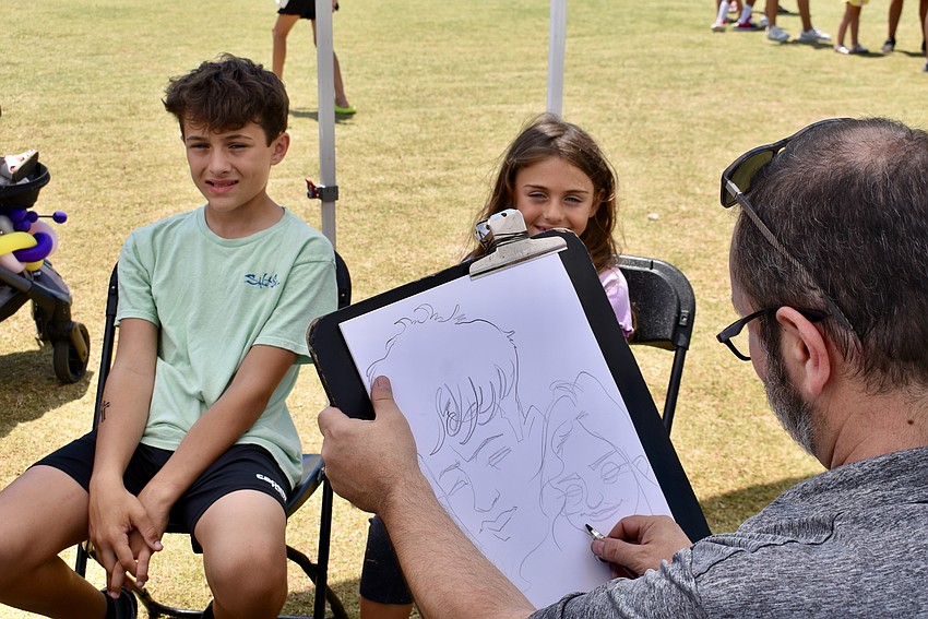 Venice residents Luca and Chiara Pignatora get a caricature of themselves.