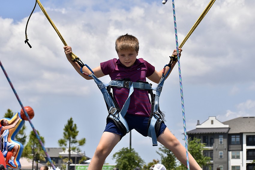 Lakewood Ranch resident Alex Kasch, 10, jumps and backflips on the bungee trampoline.