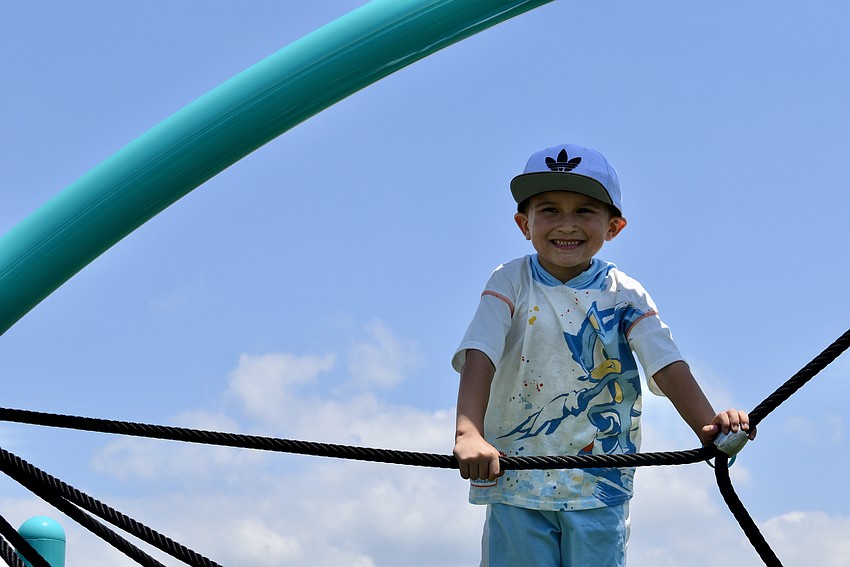Lakewood Ranch resident Sasha Frias, 5, climbs to the top of the jungle gym.