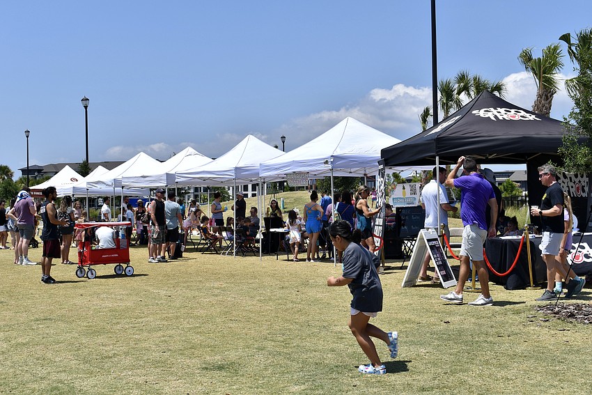 Tents line one side of the park to offer face painting, balloon animals, caricatures and music lessons.