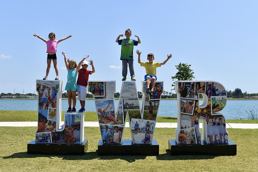 Frances Kozma, Grace Martin, Rafael Gunderson, George Kozma and John Martin strike a pose in Waterside Park.