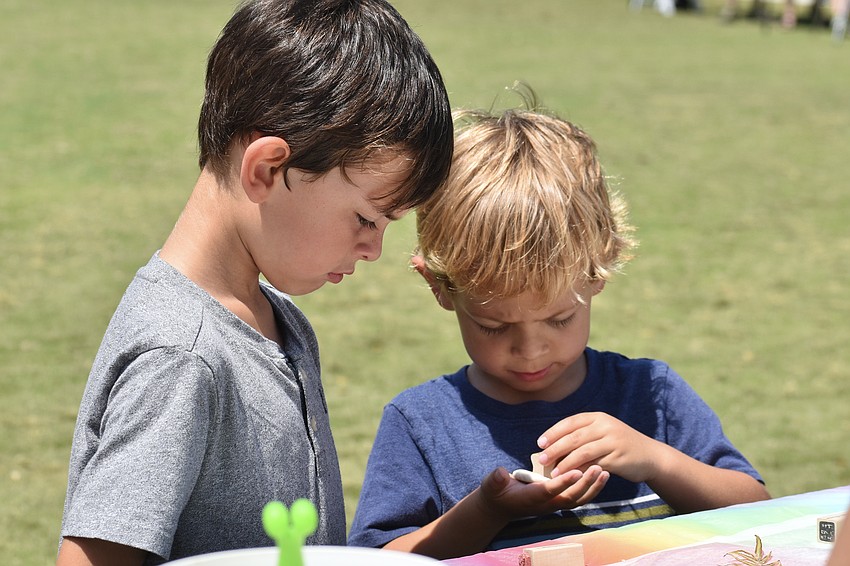Griffin Miller, 6, and his brother Asher Miller, 4, create nature impressions in clay with Art Center Sarasota.