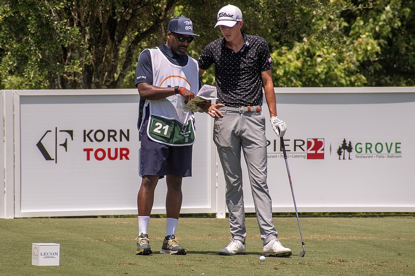 Ross Steelman talks with his caddy about his tee shot on the No. 17 hole at Lakewood National Golf Club on day three of the 2024 LECOM Suncoast Classic. Steelman would par the hole.