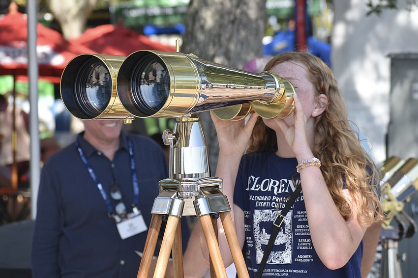 Reagan Stanley, 12, takes a look through a pair of binoculars.