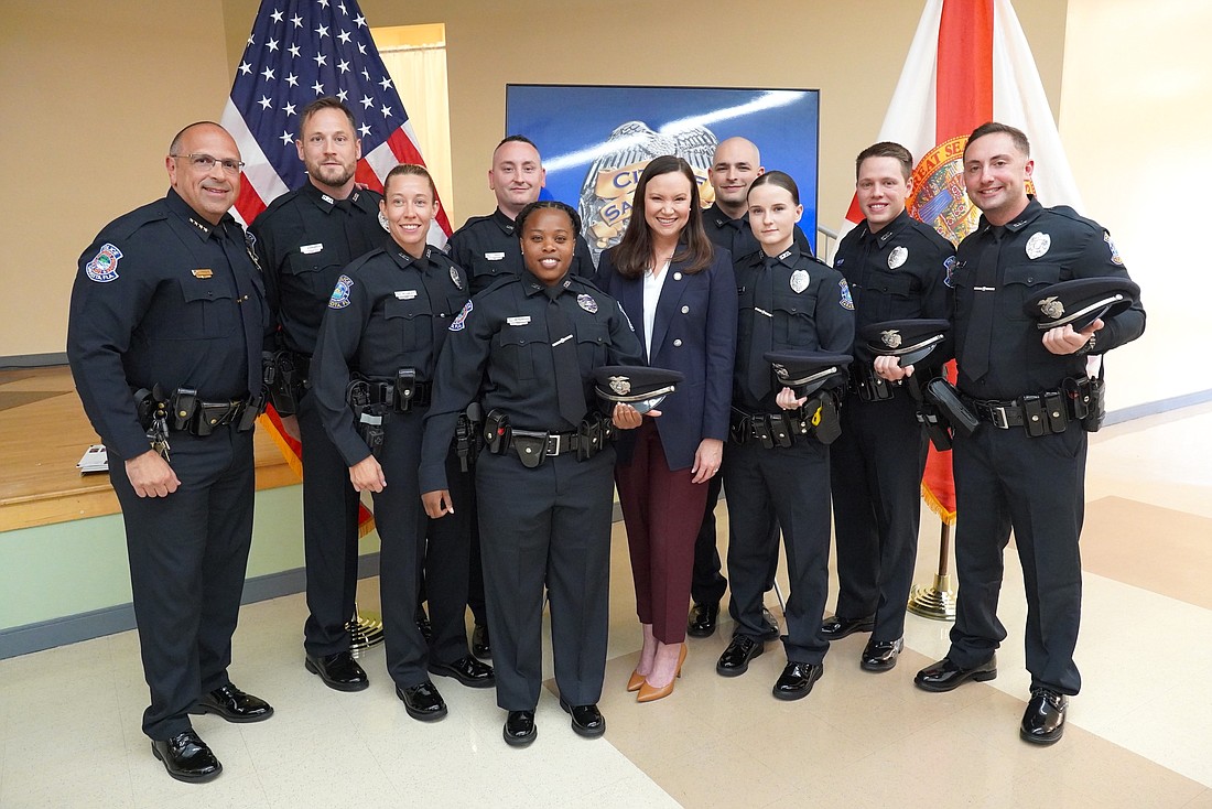 Eight of nine newly minted officers of the Sarasota Police Department with Police Chief Rex Troche and guest speaker Florida Attorney General Ashley Moody.