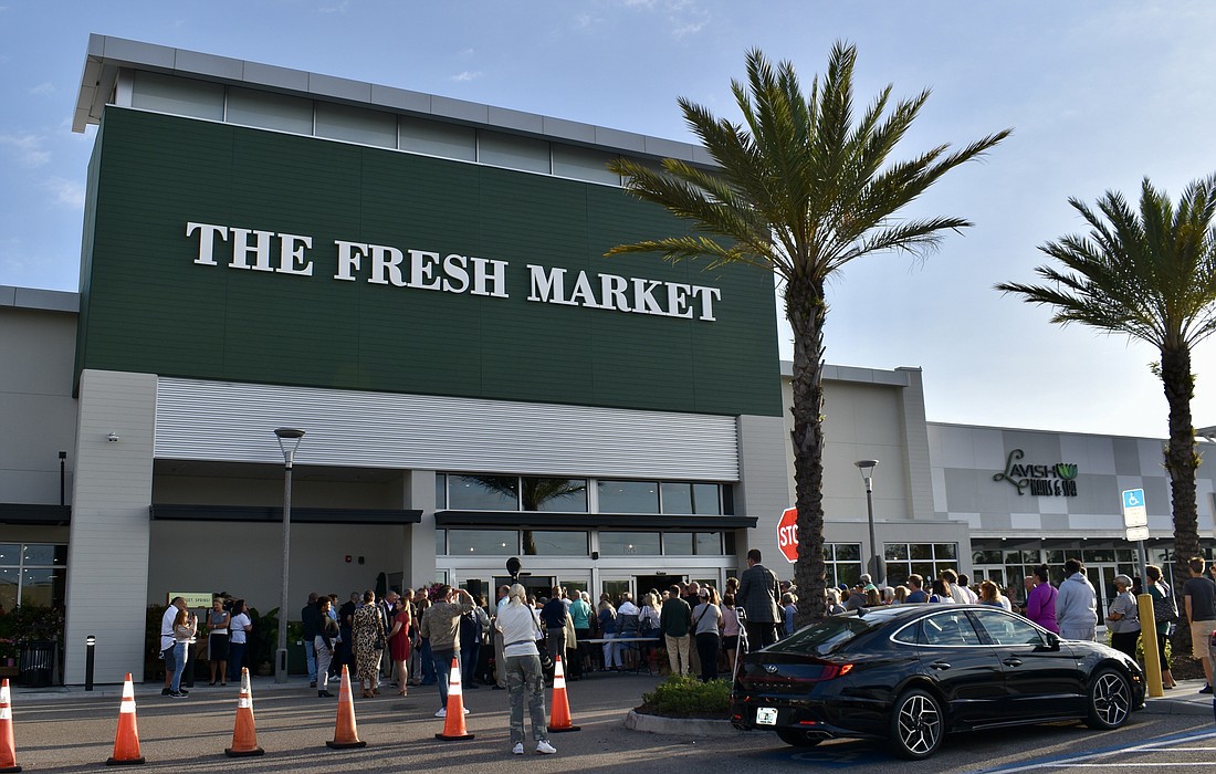 Residents line up to get into The Fresh Market on April 24.