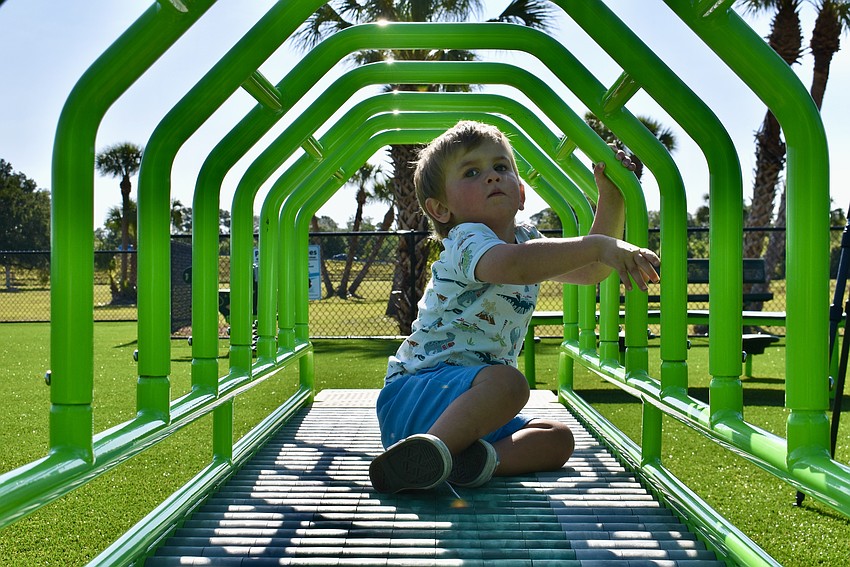 Parrish resident Hudson Vestal explores the new playground.