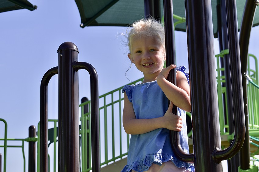 Parrish resident Jane Kukulka, 5, visits the new playground with her little brother Jeff and her dad Ryan.
