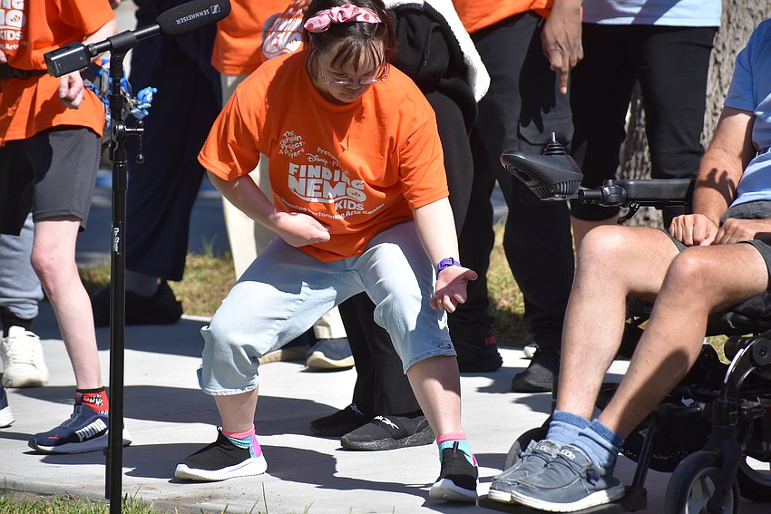 Natalie Pernia performs a solo on the air guitar during 