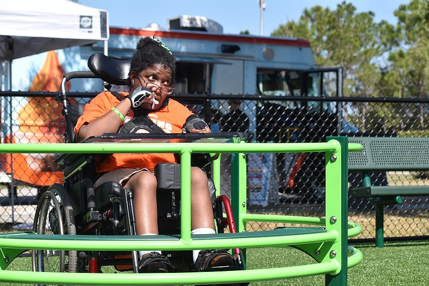 Rickena Gissendanner gets a ride on the merry-go-round.