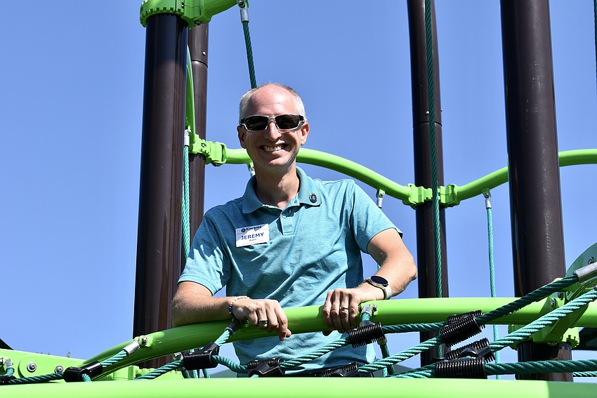 Kiwanis Governor-elect Jeremy Riehl climbs to the top of the jungle gym.