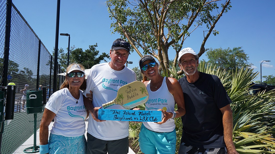 Kathie Williams, Alan Williams, Sheila Loccisano and Barry Levine pose with The Golden Paddle after the Bayfront Park team won the challenge.