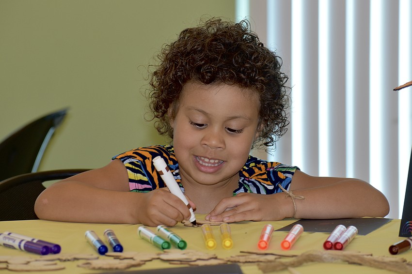 Harley Cid gets engaged in a coloring activity.