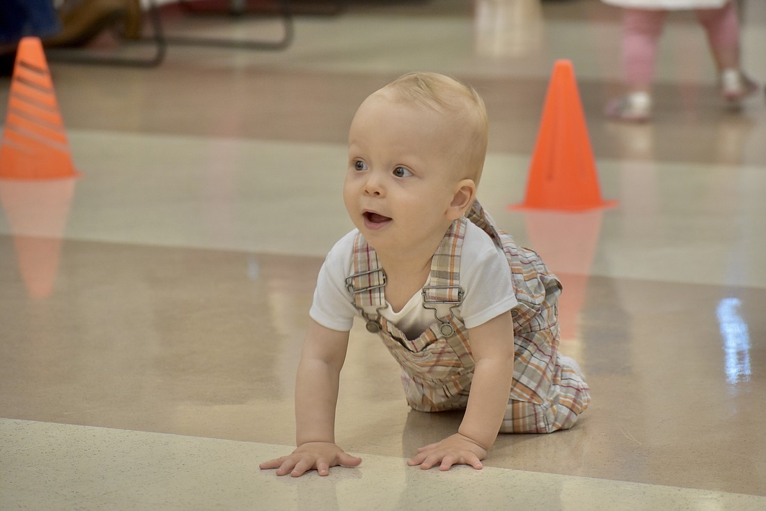 Alexander Simon, 1, makes his way across the floor in the Diaper Derby.