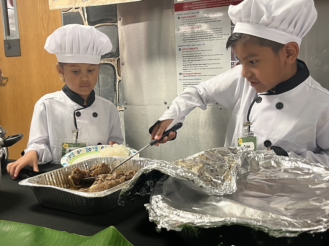 Kindergartners Selah Ortiz and Erick Gonzales-Dimas put their culinary skills to the test as the chefs at the Banana Leaf Restaurant.