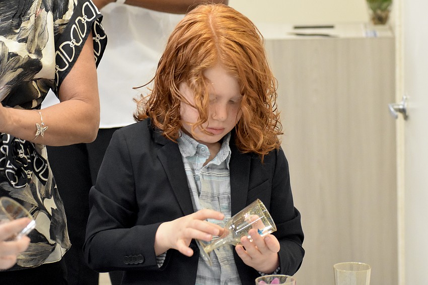 Joah Sigal-Verier, 6, decorates his cup.