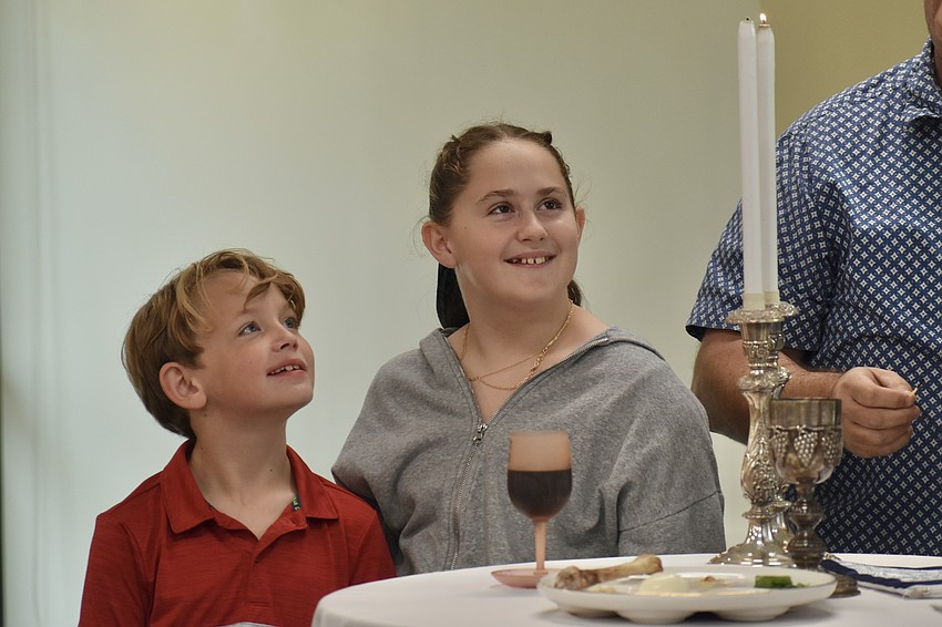 Zachary Friedman, 7 and Eloise Friedman, 11, joined their parents Jason and Shera and brother William, 5, in the lighting of the candles.