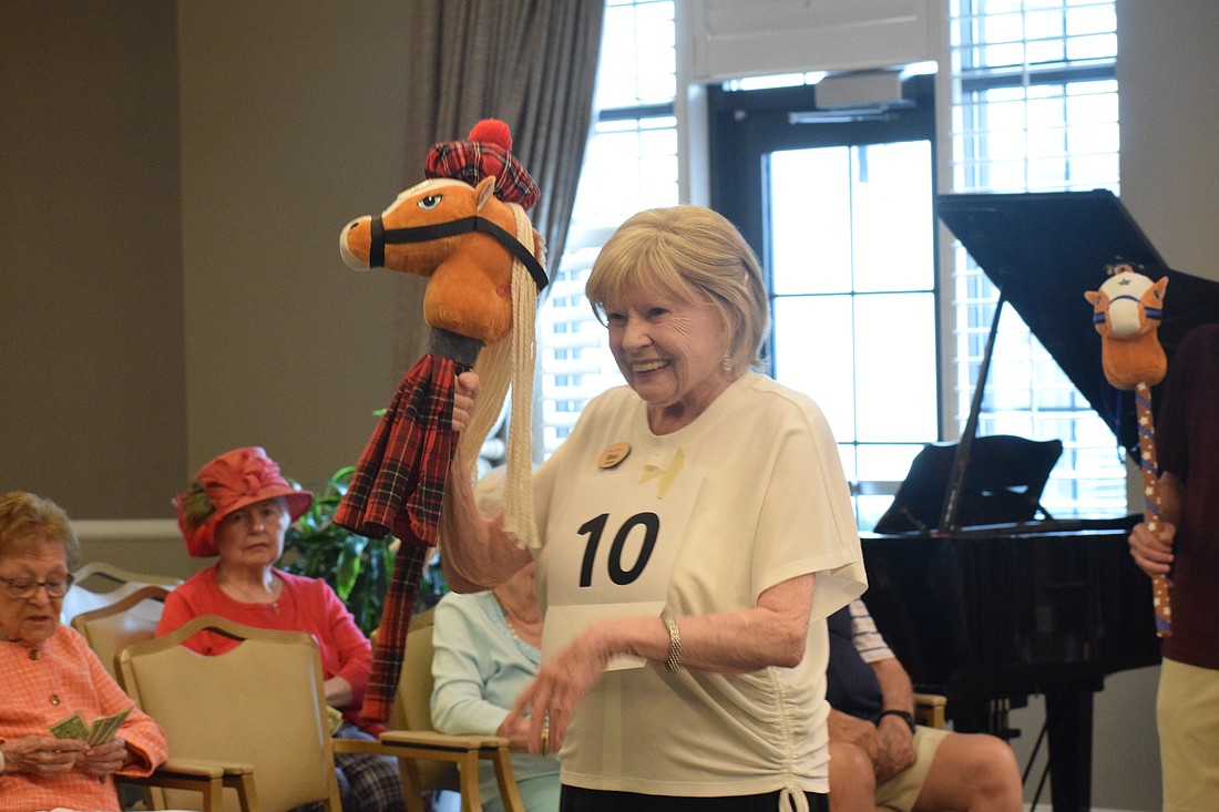 Grand Living at Lakewood Ranch resident Bea Gardner celebrates her second place victory with her horse Charlie.