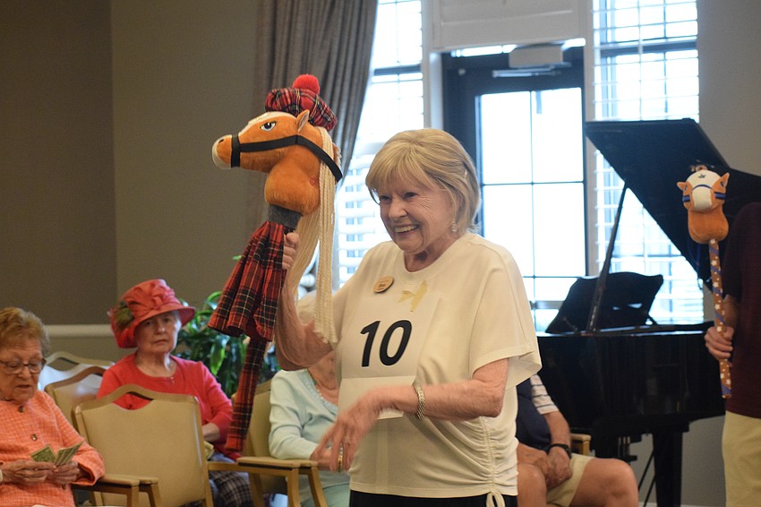 Grand Living at Lakewood Ranch resident Bea Gardner celebrates her second place victory with her horse Charlie.