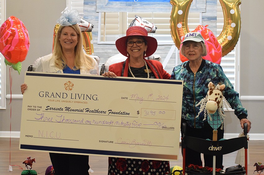 Lisa Biach, a clinical case manager in Sarasota Memorial Hospital's neonatal intensive care unit, is grateful for the donation from Grand Living at Lakewood Ranch, presented by Crow Barnett, a facet assistant, and Liz Fillipo, a resident.