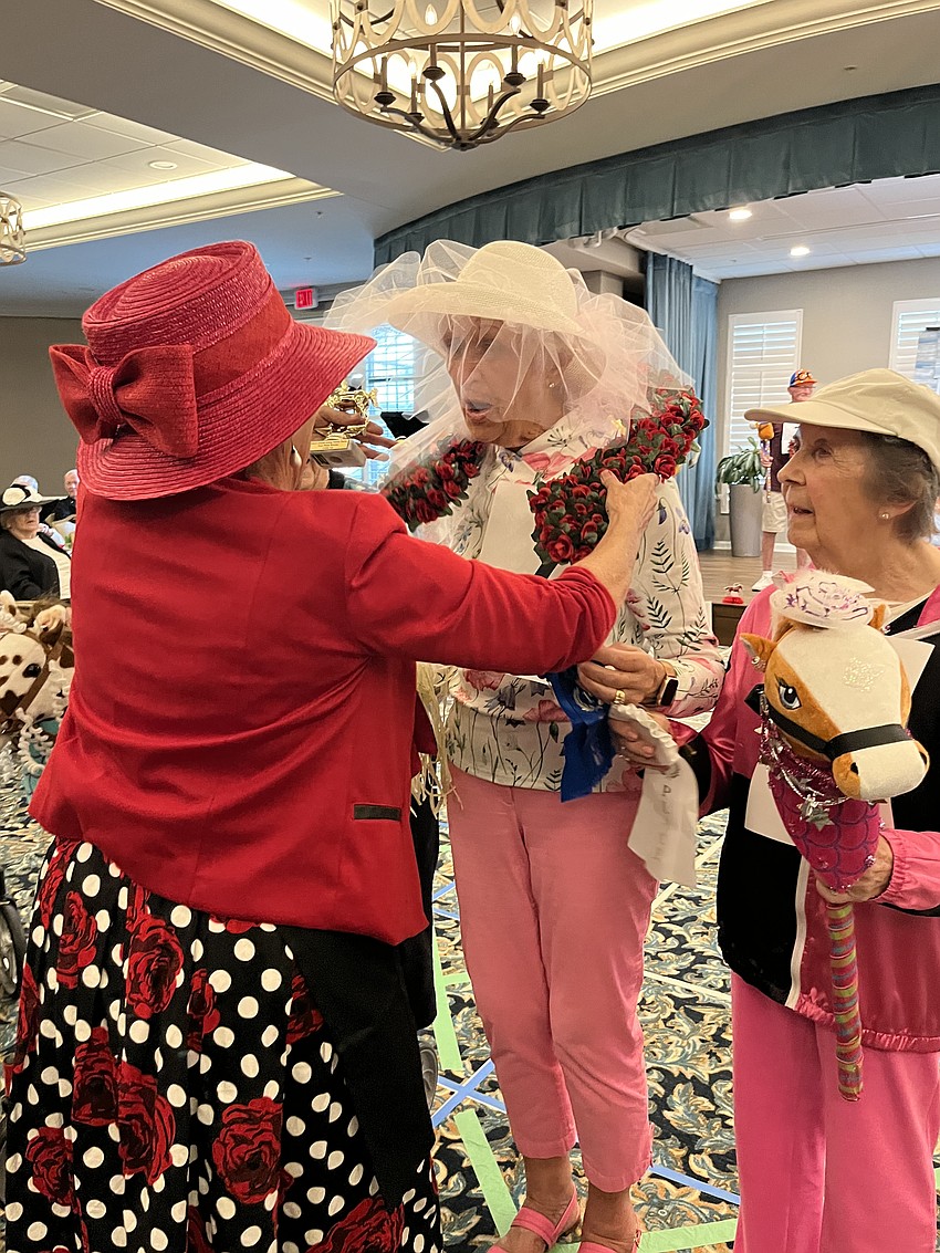 Crow Barnett, a facet assistant at Grand Living at Lakewood Ranch, congratulates Ellie Stoddard and her horse, Powder Puff, on their first place win.