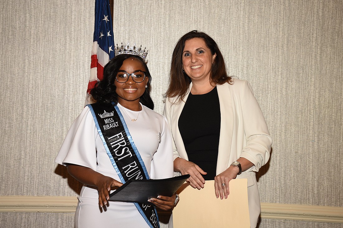 Mya Ingram, a student at Jean Ribault High School, was awarded the first speech contest prize by Alex Hill, a JBA Law Week Committee member.