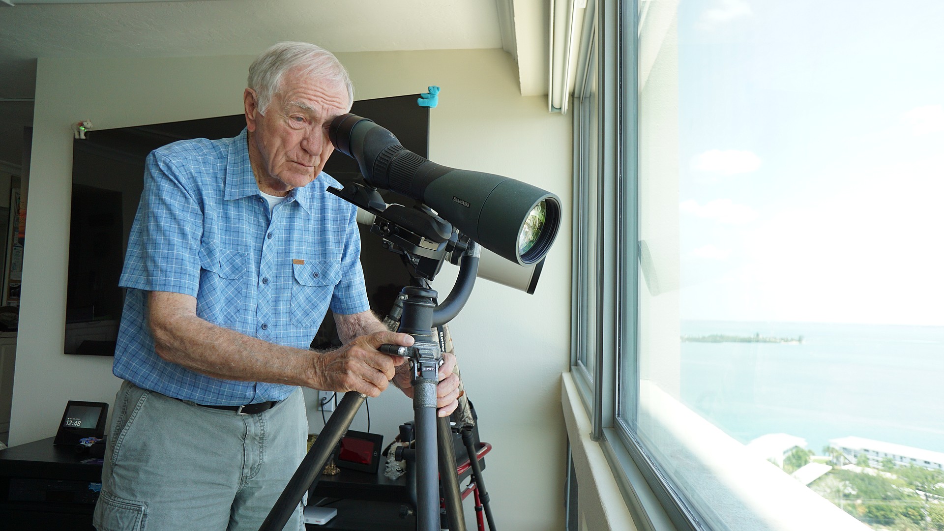 Lou Newman observing the Plymouth Harbor rookery from his apartment.