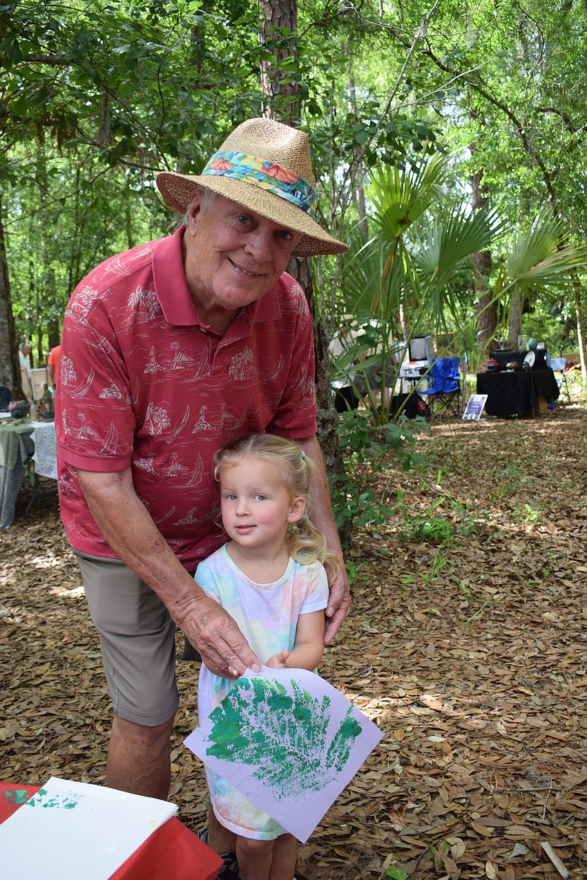 East County's Michael Bolton and his 3-year-old granddaughter Merritt Carson show off their artwork.