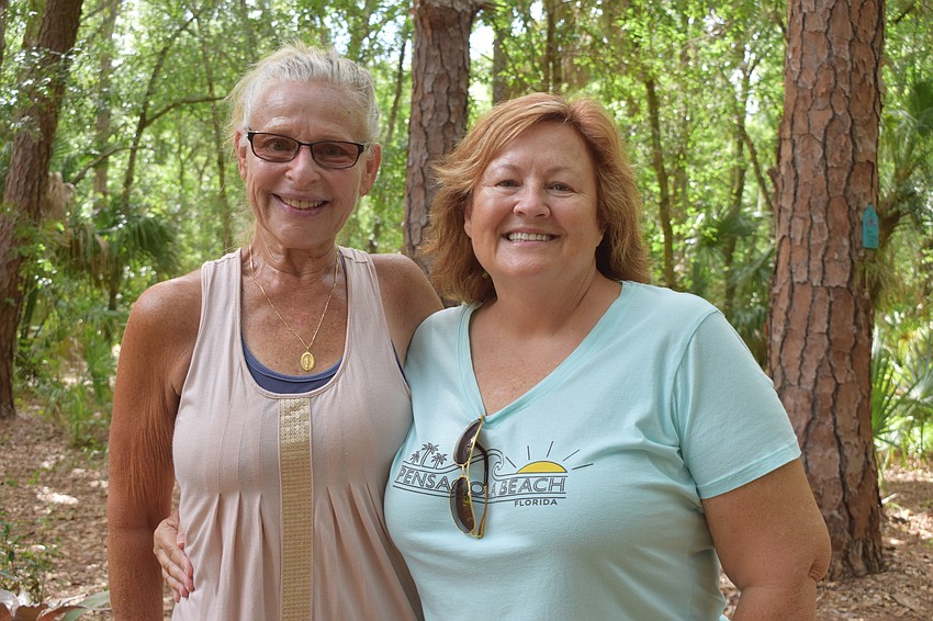 Cresswind's Cindy Meibach and Dianna Kersnick take their time seeing the various artists' work on the Peaceful Path.
