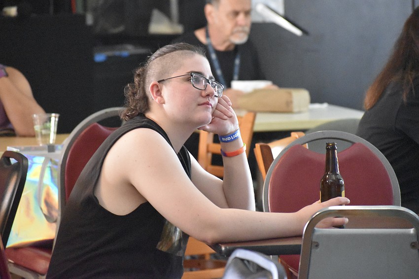 Bren Bacon watches a performance by Zeta the Babe.