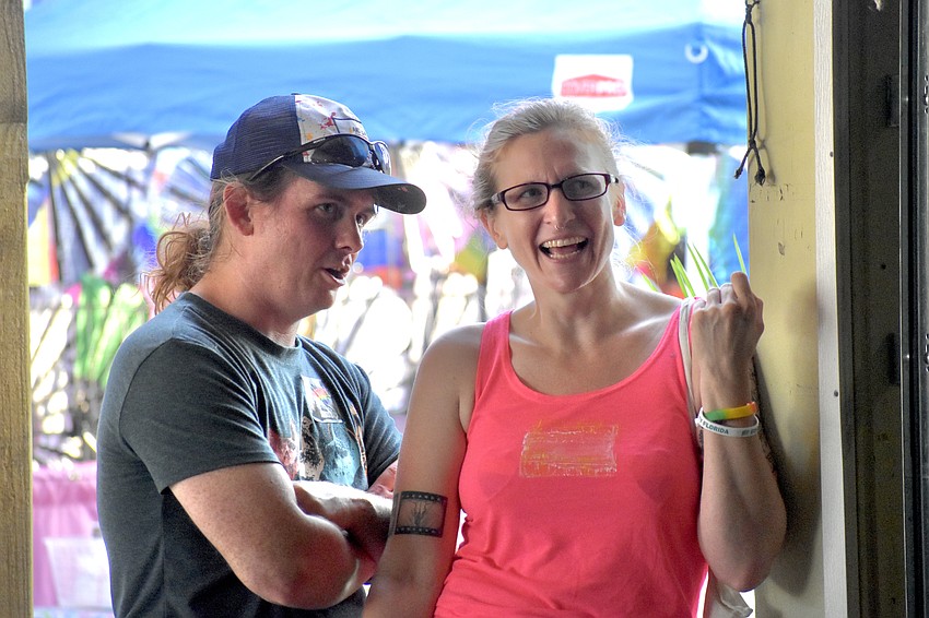 Reid Overton and his wife Leigh Hackney watch a performance.